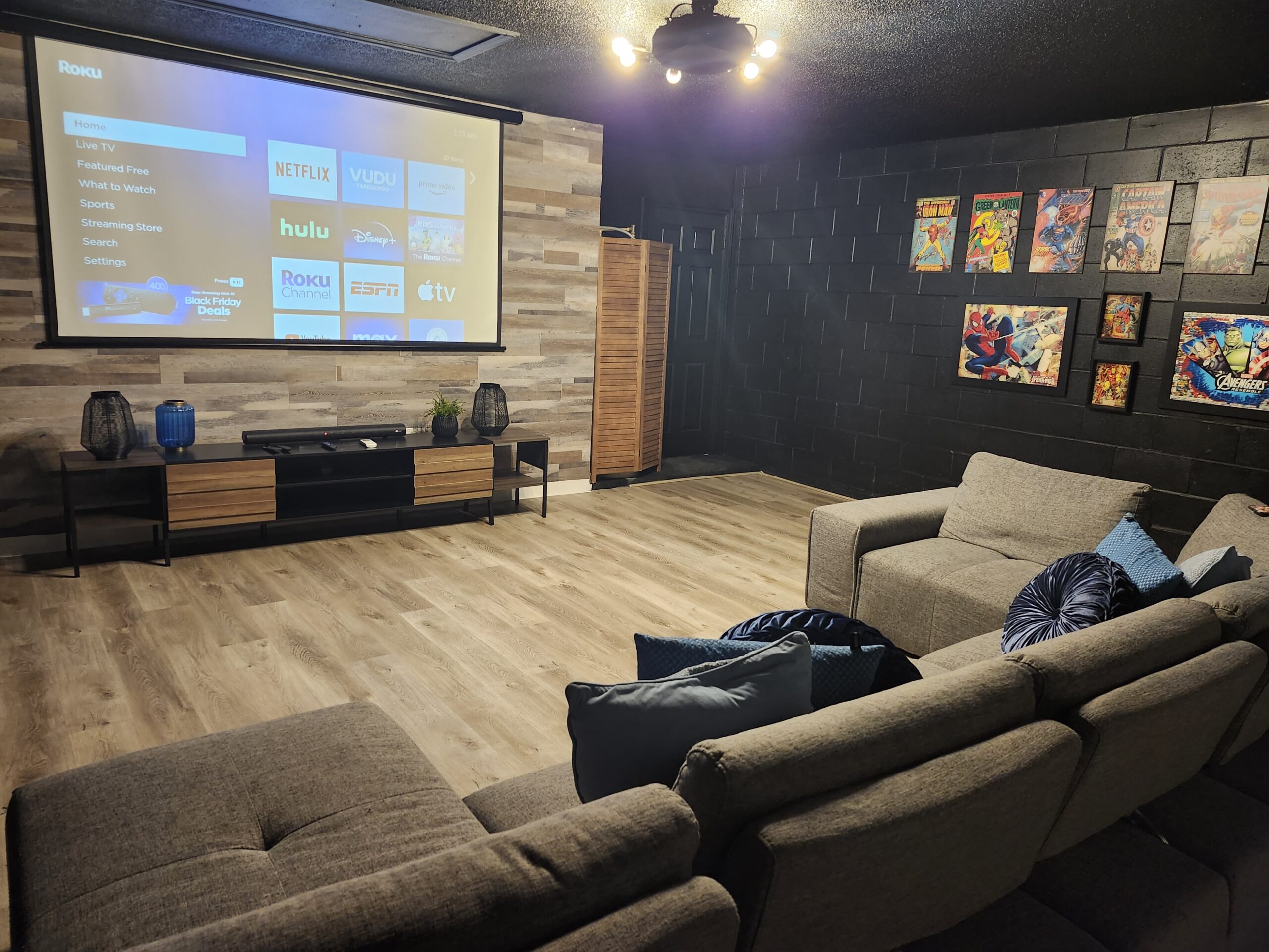 Marvel comic book themed home theater in an Orlando vacation rental with projector screen and framed comic art