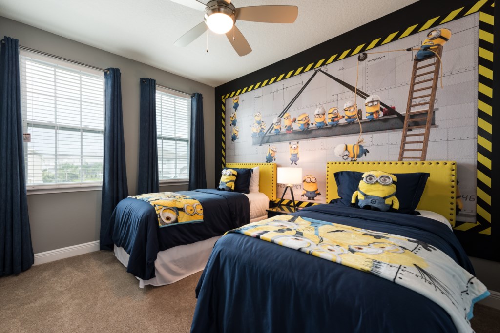 Minions themed bedroom in an Orlando vacation rental with construction crane mural, hard hat decor and caution-tape border