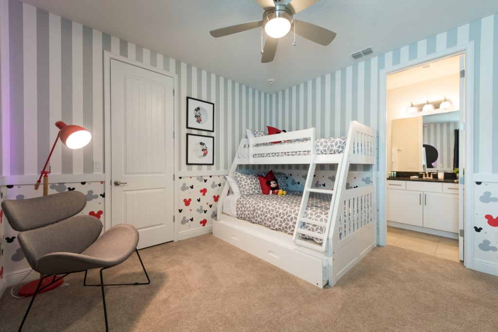 Classic Mickey Mouse striped themed bedroom in an Orlando vacation rental with striped wallpaper and white bunk bed